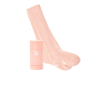 Overnight Heel Repair Set with moisturizing Heel Balm stick and soft pink cozy socks on white background