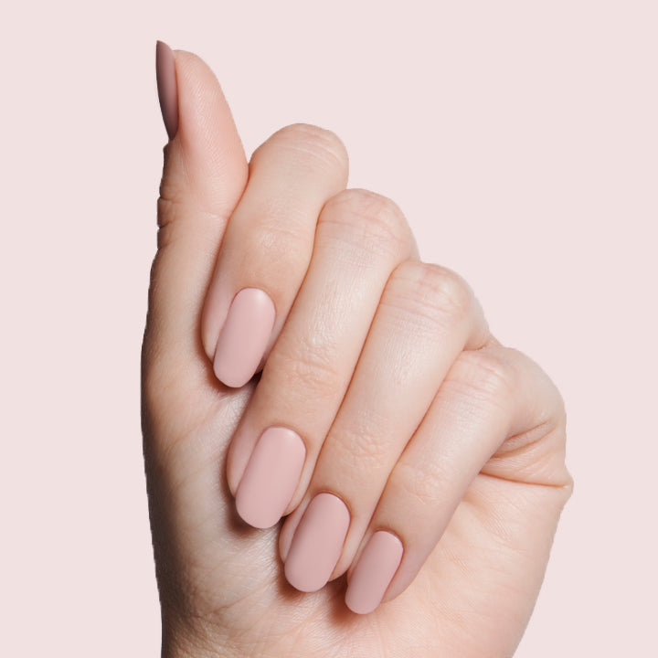 Hand showing soft matte nails coated with The Matte Top Coat for a smooth and long-lasting manicure finish