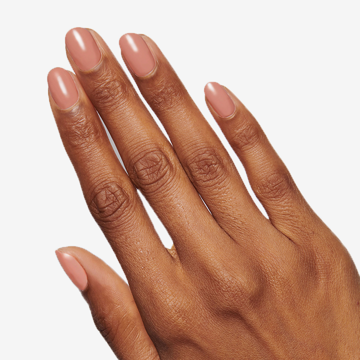 Hand with glossy nude manicure showcasing Long Lasting Top Coat for durable at-home mani shine and protection