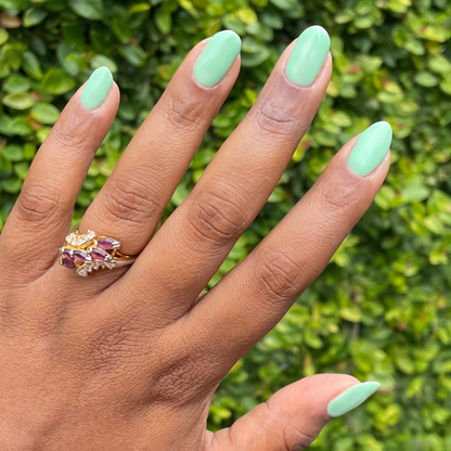 Hand with nails painted in a cool pastel green using Aced It - Gel for a smooth, long-lasting manicure at home
