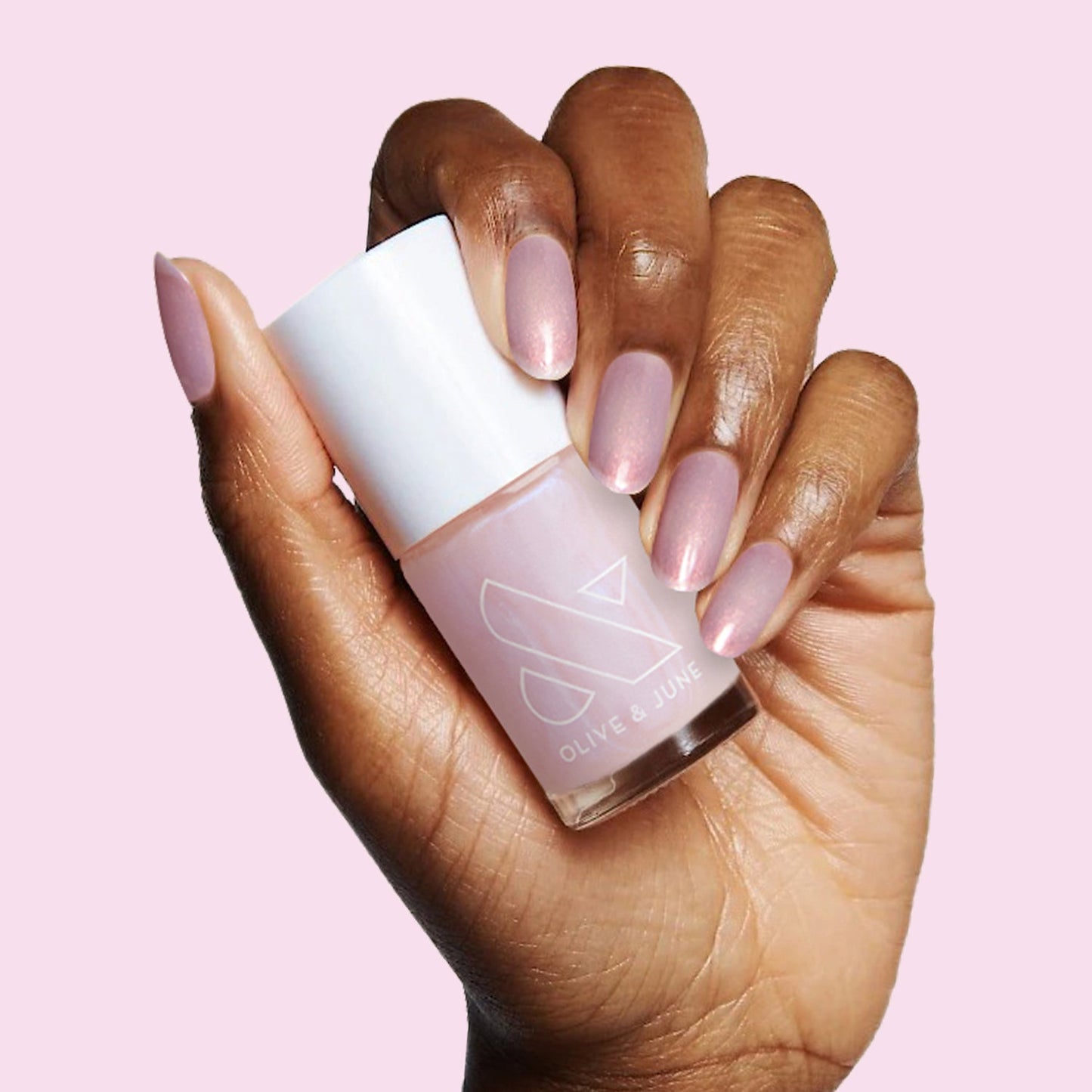Pink Goldfish sheer pink iridescent nail polish on hand, perfect for soft at-home manicures and layering effects
