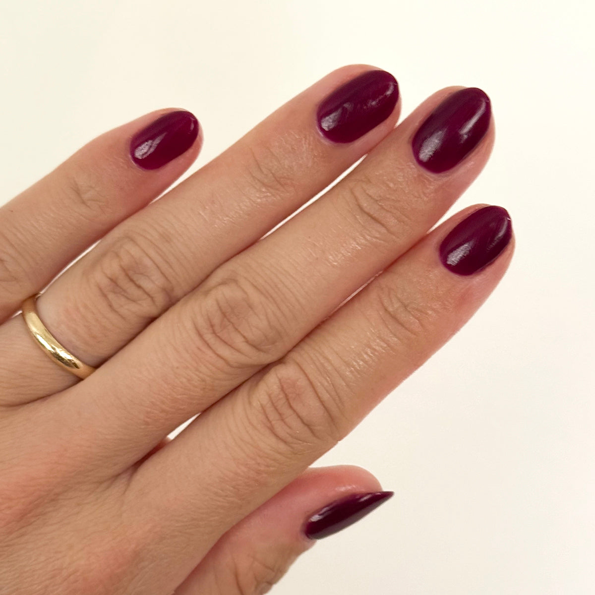 Plaza - Gel polished nails in deep mulberry purple with a glossy finish for a long-lasting manicure by Olive and June
