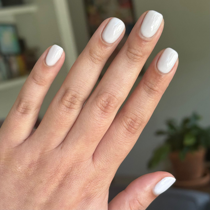 Hand with short rounded nails painted in Sculpture Wing - Gel in cool muted lavender grey for a fresh mani look
