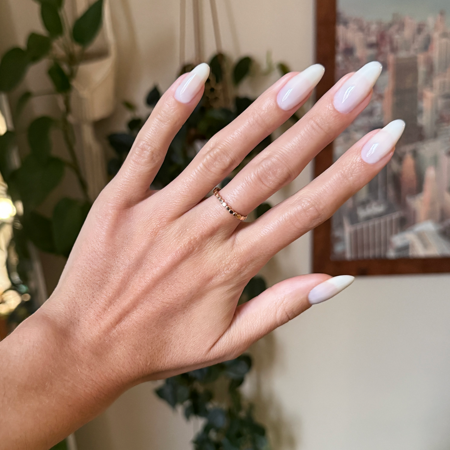 Sugar Glow - Builder Gel displayed on almond-shaped nails with a glossy sheer milky white finish for a natural mani look