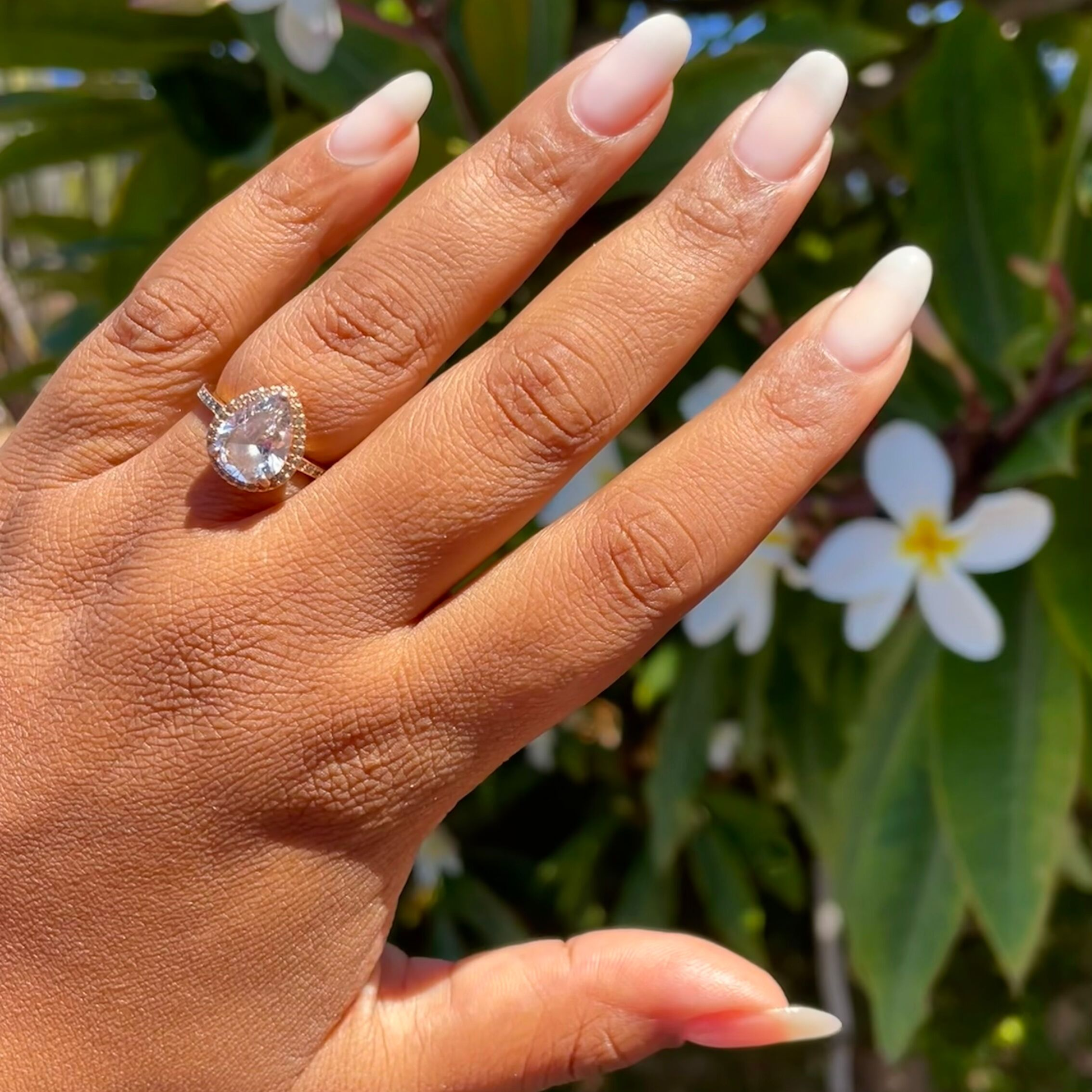 Sugar Glow - Builder Gel on natural almond-shaped nails with a smooth, sheer soft white finish in outdoor natural light