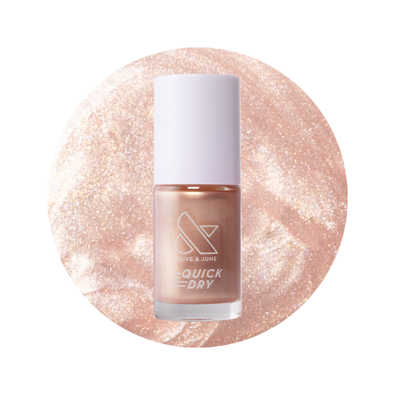 Olive and June Supernova quick dry gel polish bottle shown with shimmering sheer pink nail polish color background