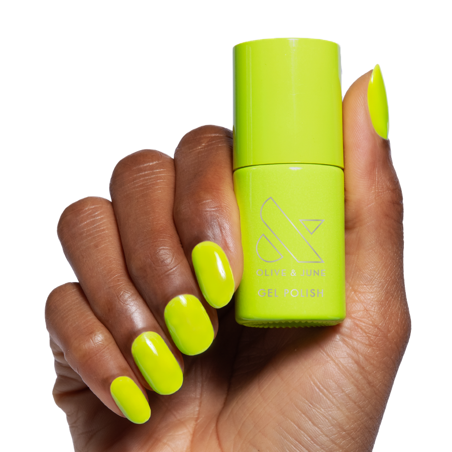 Time To Re-apply - Gel neon yellow green gel polish on hand holding matching bottle for bright manicure look