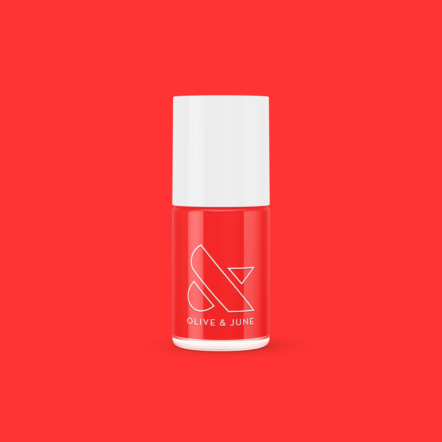 Lava nail polish bottle in vibrant spicy orange red from Olive and June against solid red background