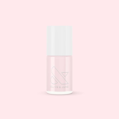 Bottle of Olive and June PINK SANDS nail polish in soft sun-bleached pink for an easy at-home mani or pedi